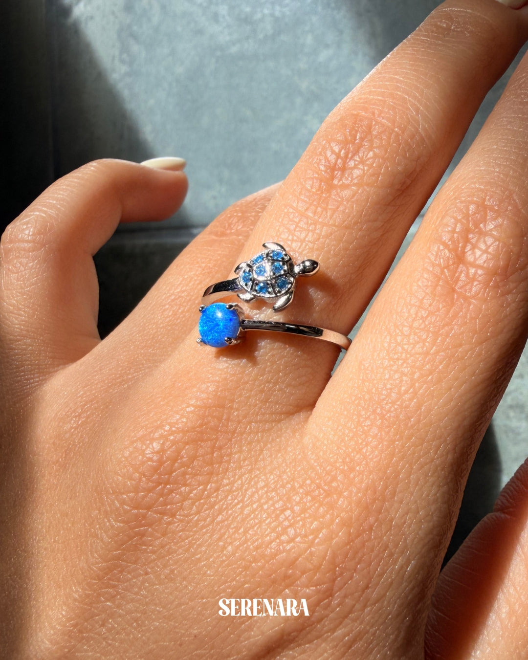 A sterling silver animal ring, hand-polished, on a finger