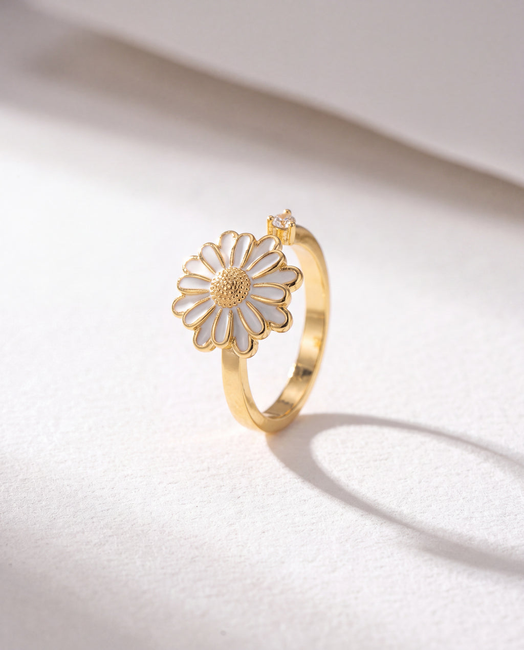 White Sunflower Serenara Anxiety Ring standing upright on white textured watercolor paper, soft shadow