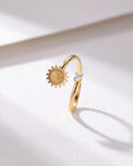 Basic Sunflower Serenara Anxiety Ring standing upright on white textured watercolor paper, soft shadow