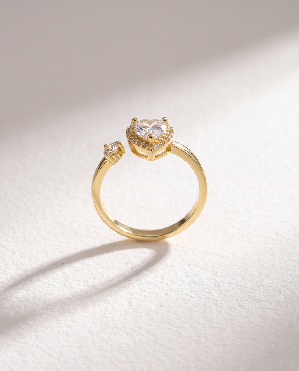 Heart Zircon Serenara Anxiety Ring standing upright on white textured watercolor paper, soft shadow