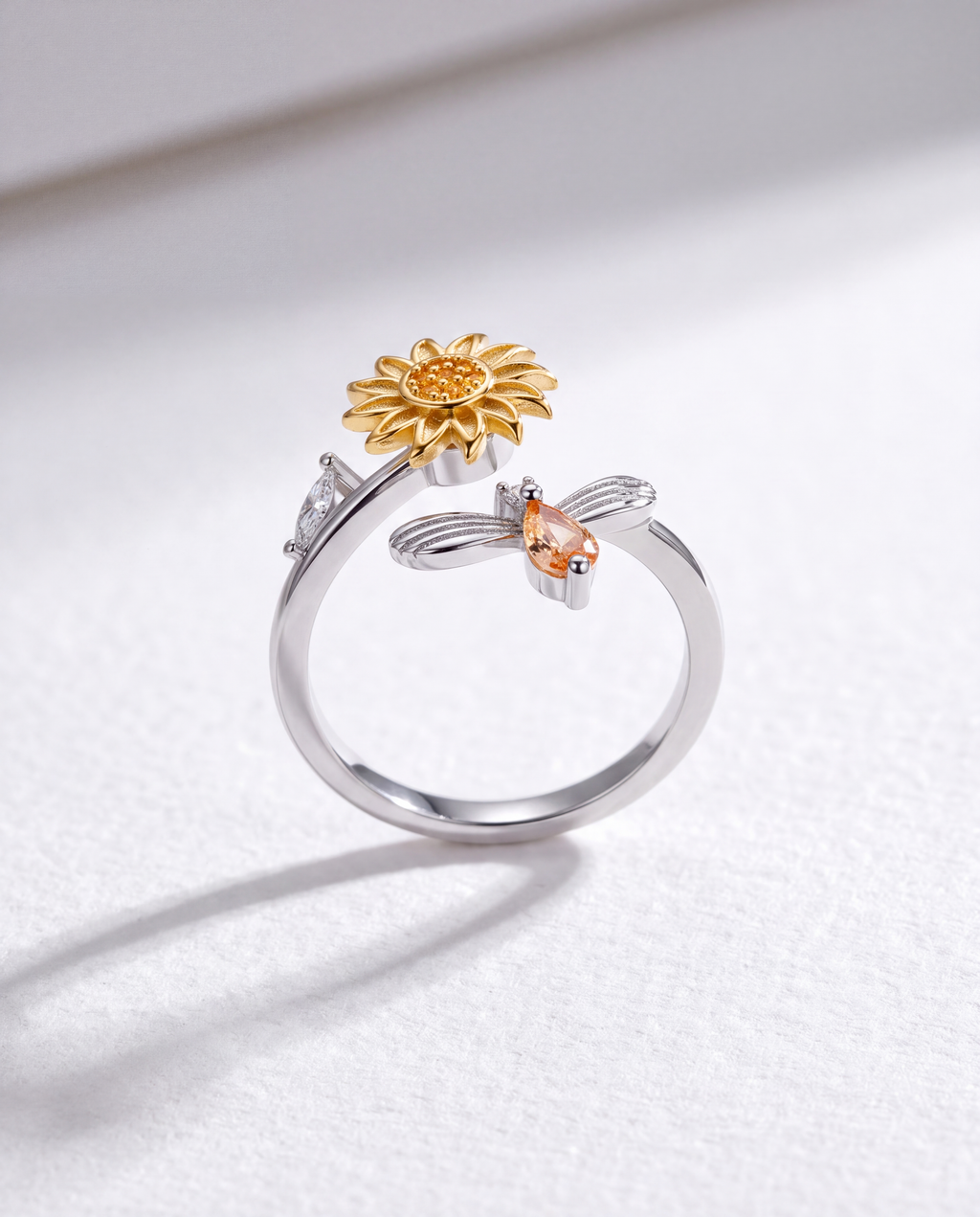 Sunflower and Bee Serenara Anxiety Ring standing upright on white textured watercolor paper, soft shadow