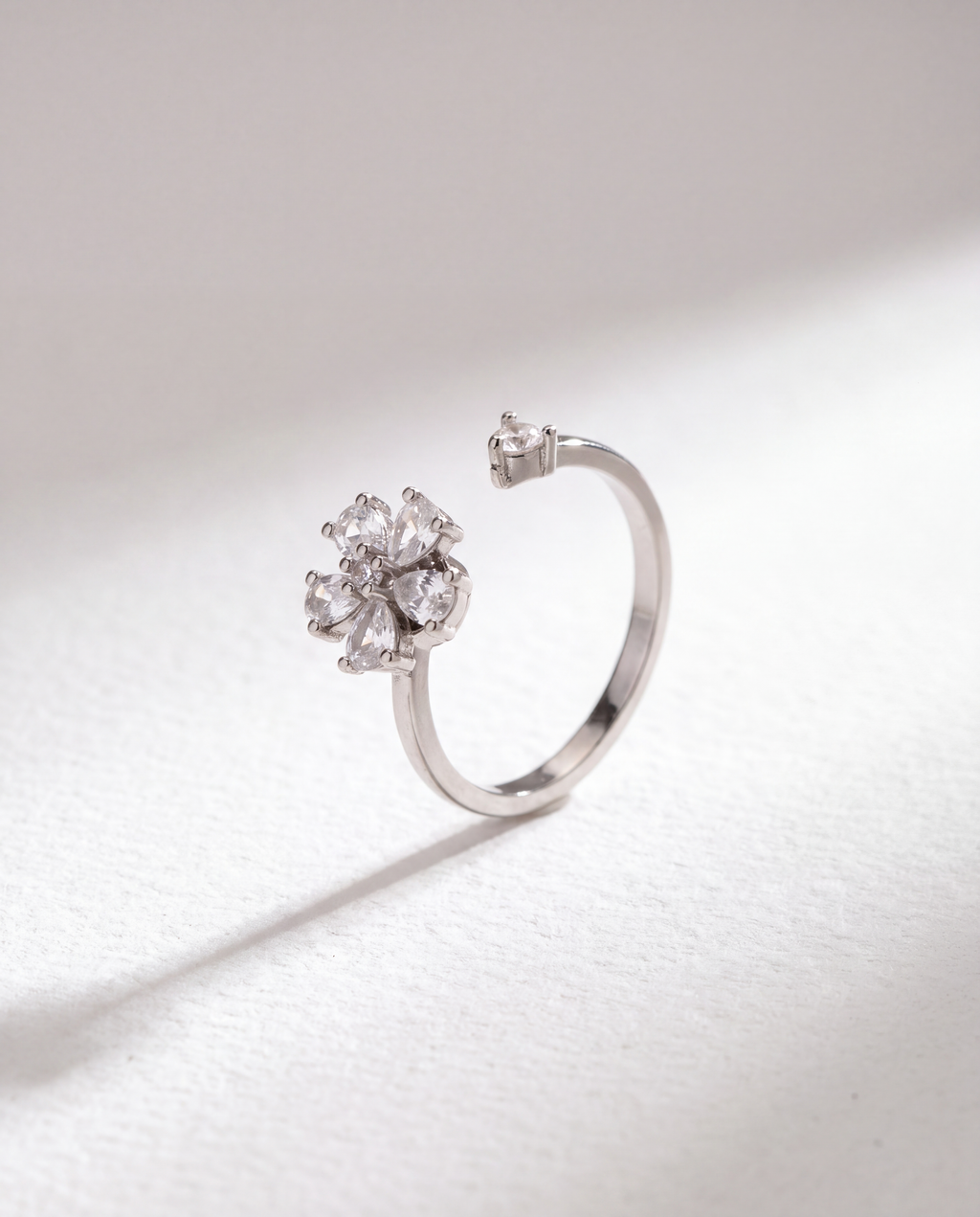 Basic Flower Serenara Anxiety Ring standing upright on white textured watercolor paper, soft shadow