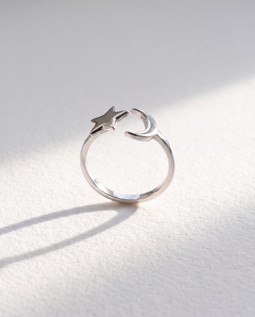 Sun and Moon Serenara Anxiety Ring standing upright on white textured watercolor paper, soft shadow